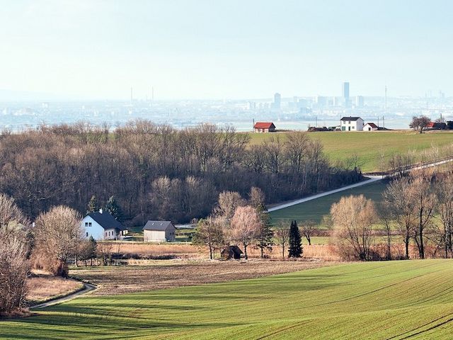 Dörfliche Landschaft mit Stadt im Hintergrund