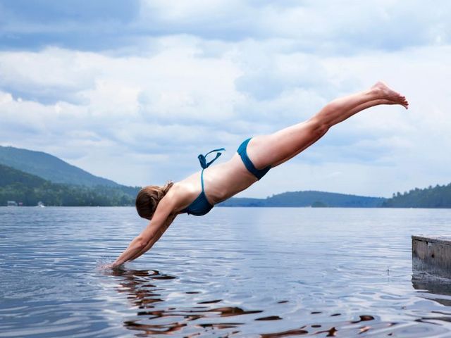 A girl jumps into the lake
