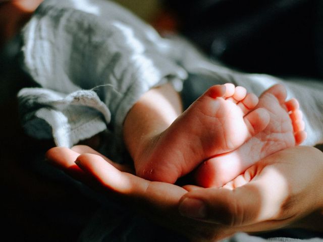 Baby's feet in a hand