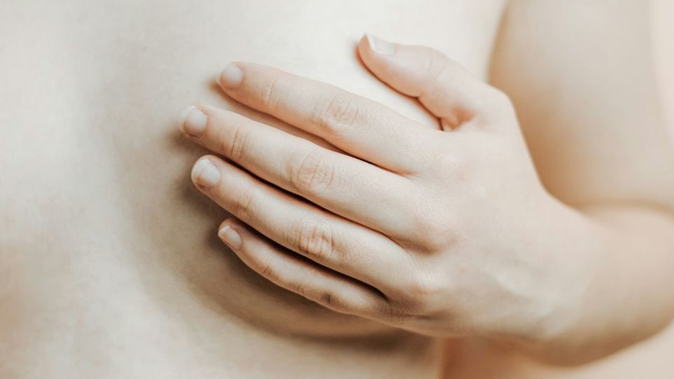 Female breast covered by hand