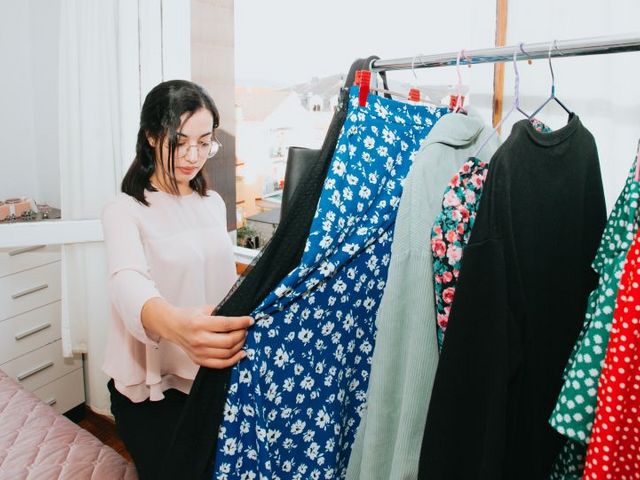 Young woman in front of a clothes rack