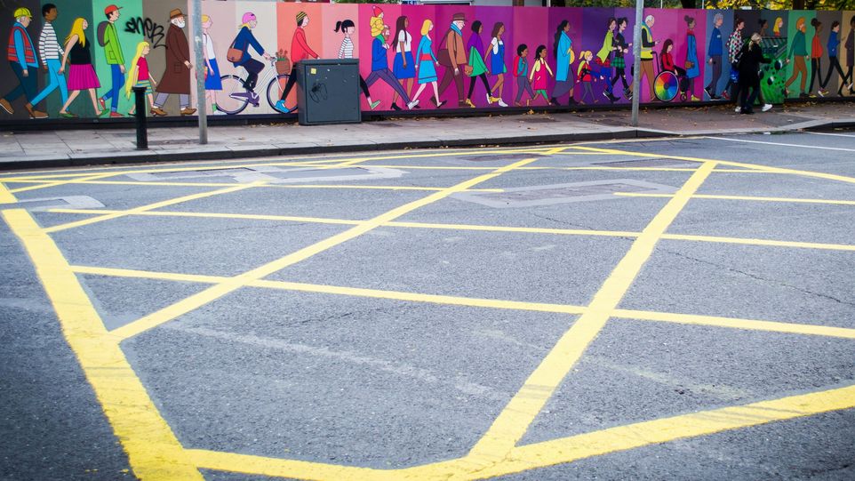 Wall with people of different ages painted on it