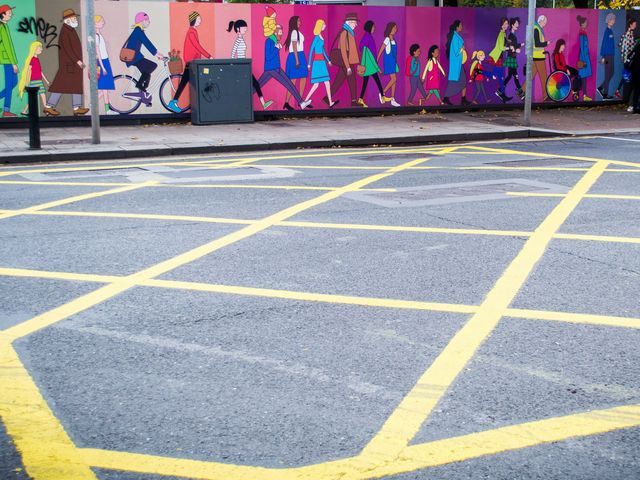 Wall with people of different ages painted on it