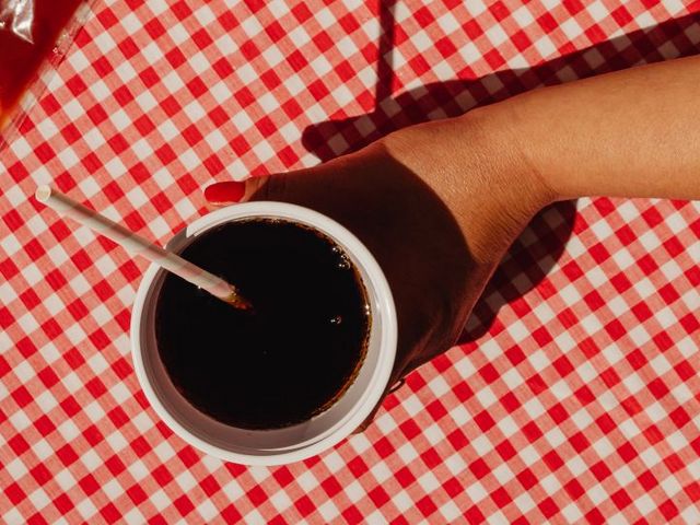 Woman's hand holding cola cup