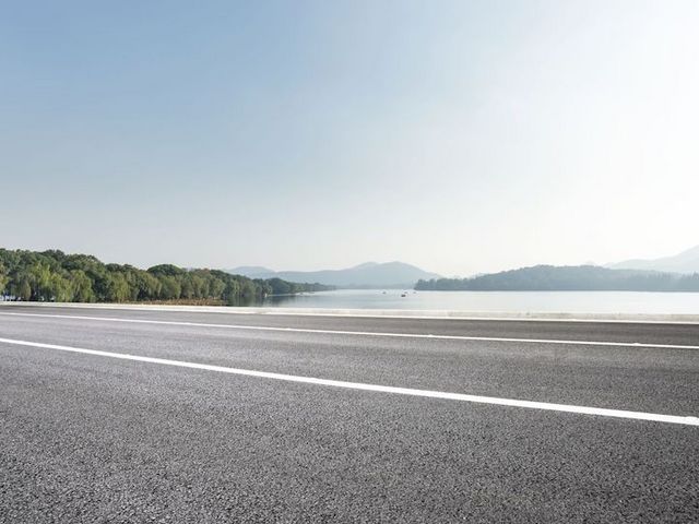 Paved road by a lake Paved road by a lake