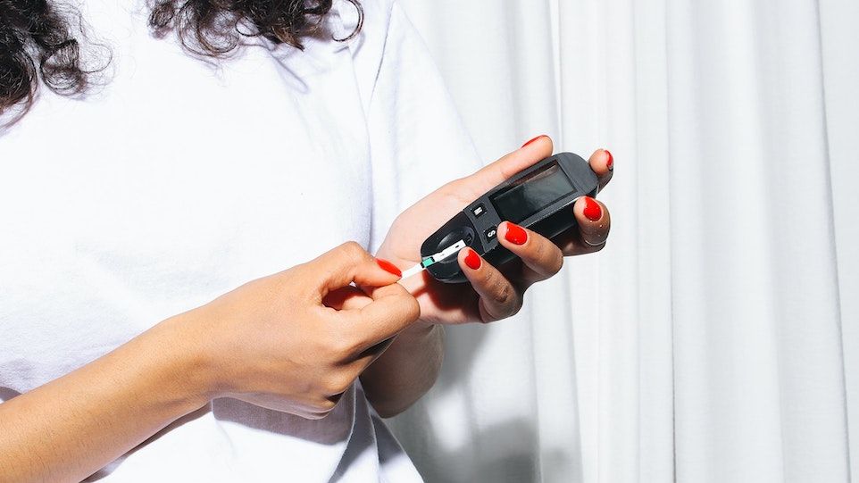 Postpartale Diabetes-Screenings werden nur in knapp 40 Prozent der Fälle in Anspruch genommen. Frau mit rot lackierten Nägeln misst ihren Blutzucker