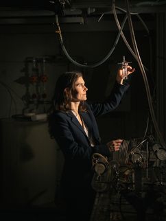 Die Physikerin Mira Pöhlker schaut auf ein Reagenzglas in ihrer Hand.